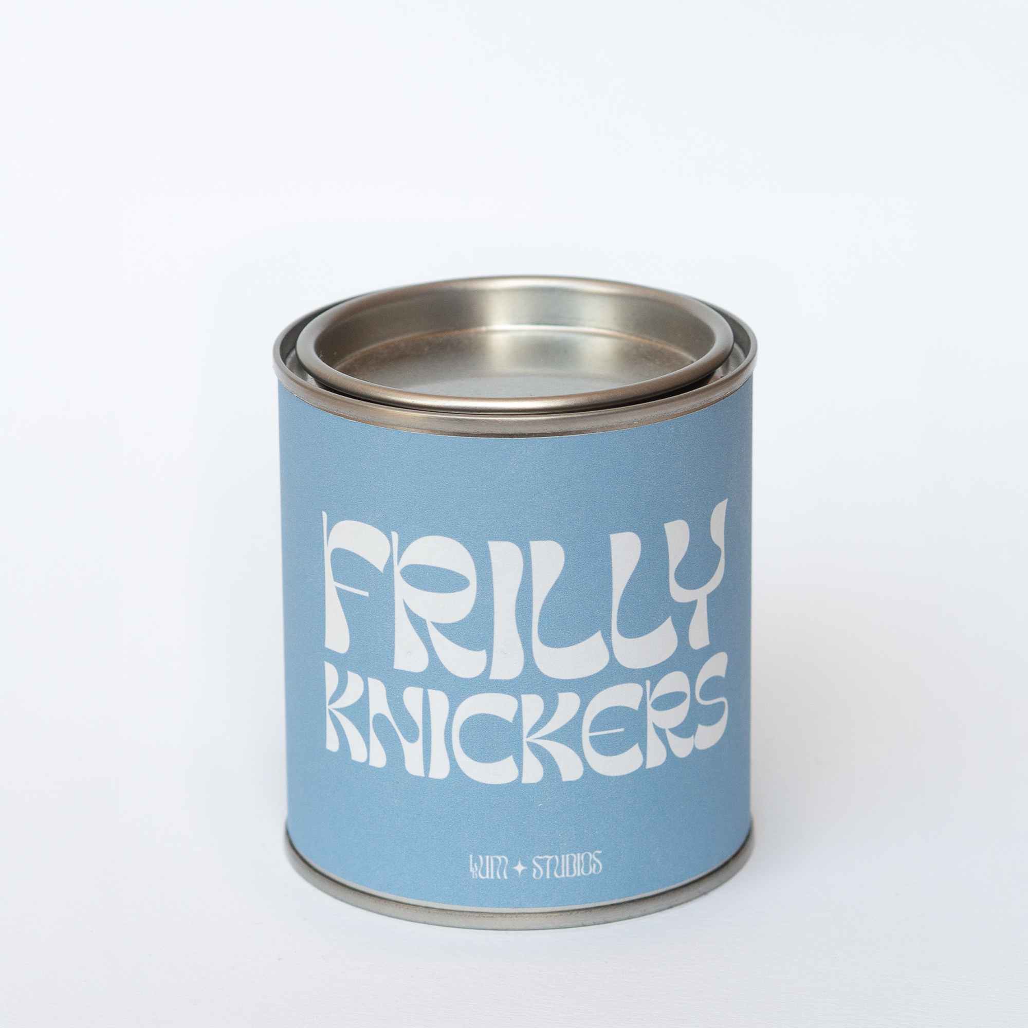 Llum Studios Frilly Knickers vegan scented candle in a reusable tin with powder blue sugarcane paper wraparound label, sustainably packaged and ethically made, on a white background