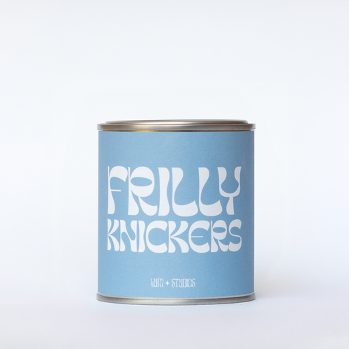 Llum Studios Frilly Knickers vegan scented candle in a reusable tin with powder blue sugarcane paper wraparound label, sustainably packaged and ethically made, on a white background