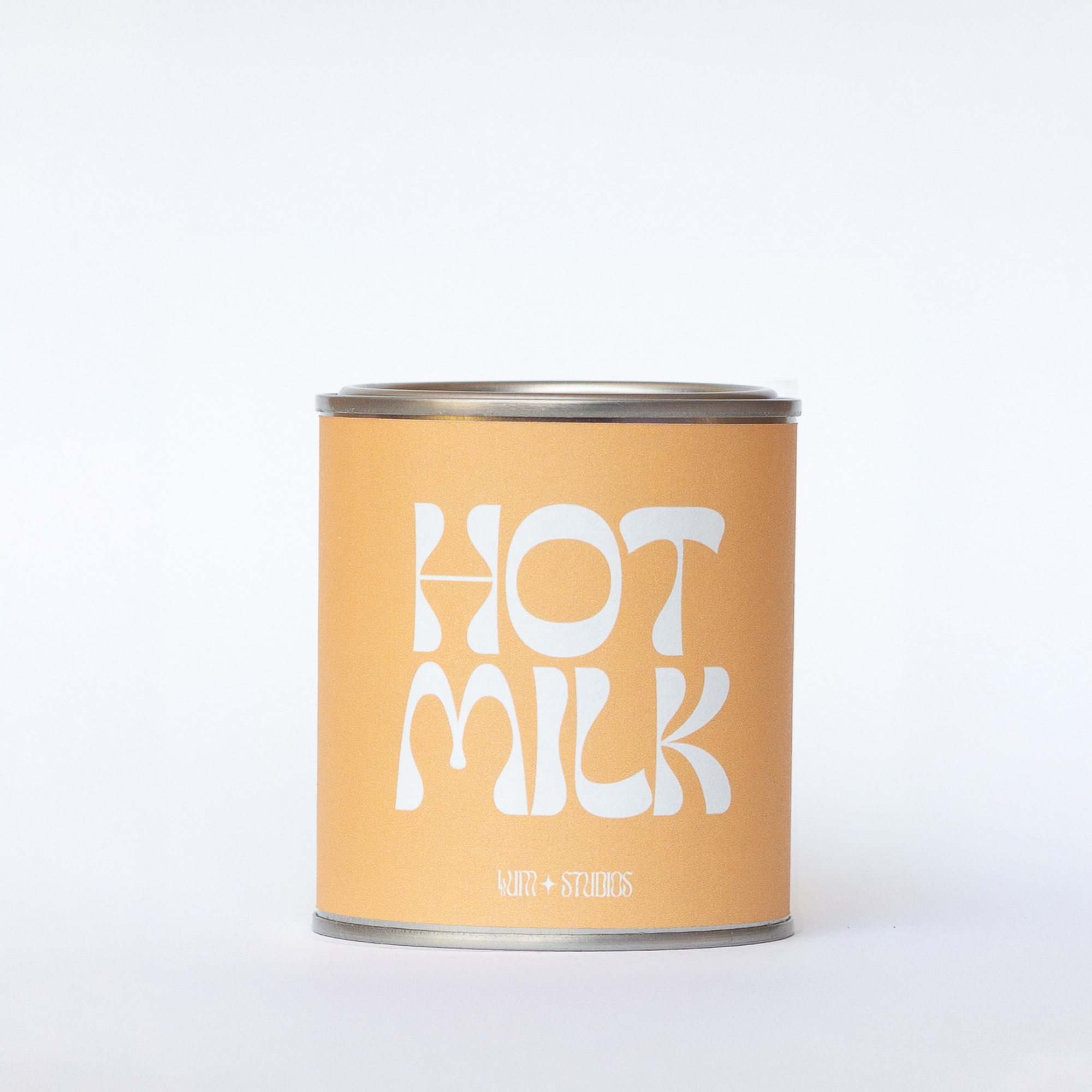 Llum Studios Hot Milk vegan scented candle in a reusable tin with warm yellow sugarcane paper wraparound label, sustainably packaged and ethically made, on a white background